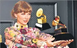  ??  ?? Taylor Swift, winner of the Album of the Year award for Folklore, poses in the media room.