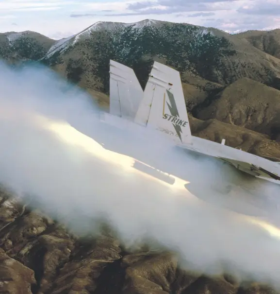  ??  ?? A Strike Weapons Test Center, NAS China Lake Hornet fires 0.5-inch Zini rockets on a test mission. U.S. Navy and Marine Corps aircraft and weapons are developed and tested at ranges to ensure that upgrades are successful and weapons will perform as...