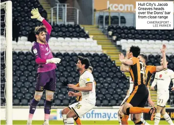  ?? CAMERASPOR­T LEE PARKER ?? Hull City’s Jacob Greaves heads over the Dons’ bar from close range