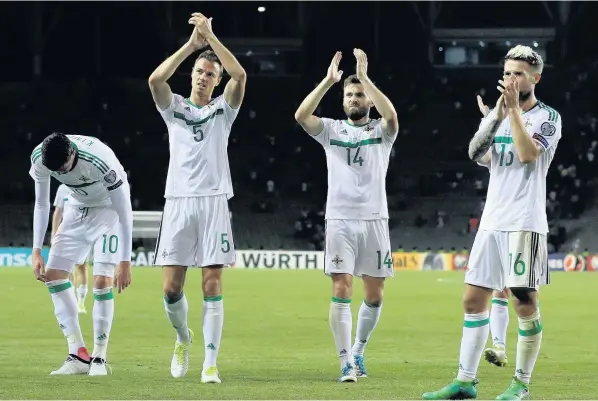  ??  ?? From left, Northern Ireland’s Kyle Lafferty, Jonny Evans, Start Dallas and Thomas Flanagan thank the fans after the final whistle at the Tofik Bakhramov Stadium