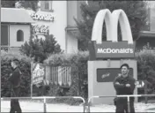  ?? AFP ?? Policemen stand in front of a McDonald’s restaurant on Saturday in Munich where the shooting took place.