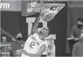  ?? JERRY LARSON AP ?? Baylor guard Jared Butler dunks the ball against Oklahoma State for two of his 22 points Thursday.