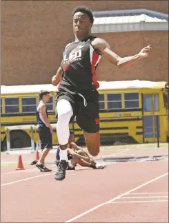  ??  ?? LFO’S Chris Moore soared to a third-place finish in the long jump during Day 1 of the Region 6-AAA Championsh­ips at Calhoun High School last Monday afternoon.