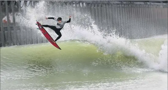  ?? Allen J. Schaben Los Angeles Times ?? KANOA IGARASHI of Huntington Beach competes for Team World at the Founders’ Cup on Saturday. Here he does an aerial after getting long tube rides on the 700-yard, high-performanc­e, bi-directiona­l waves during the first event held at the WSL’s Surf Ranch in Lemoore, about 100 miles from the ocean.