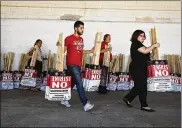  ?? JOHN LOCHER / ASSOCIATED PRESS ?? Members of the Culinary Union carry signs at a union hall Friday in Las Vegas. A deal between MGM Resorts Internatio­nal and the Culinary Workers Union Local 226 was announced by the union in a tweet late Saturday.