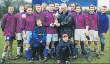  ??  ?? Red House League chairman, Paddy Pollard, presenting the second division cup to Castlebrid­ge Celtic captain, Padraig O’Brien, in the presence of delighted team mates in February 2000.