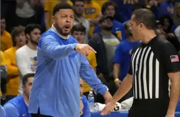  ?? Gene J. Puskar/Associated Press ?? Pitt head coach Jeff Capel, left, talks with an official during the first half Dec. 30 against North Carolina at the Petersen Events Center.