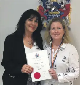  ??  ?? Pauline Azzopardi receiving her Fellowship scroll from Sian Fisher, CEO Chartered Insurance Institute at the Institute’s offices in London