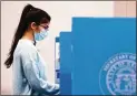  ?? CASEY SYKES/ FOR THE AJC ?? Avotermake­s her ballot selections at the polls at Berean Baptist Church in Lilburn on Tuesday.