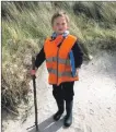  ??  ?? Lochlen Gibbs walking like an explorer with a stick he found on the beach – the school’s own John Muir.