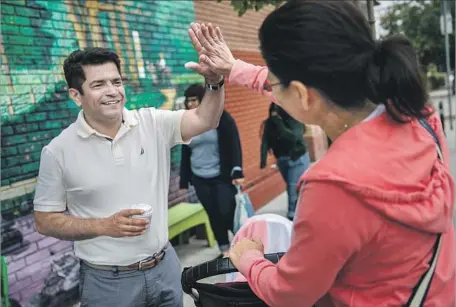  ?? Marcus Yam Los Angeles Times ?? REP. JIMMY GOMEZ (D-Los Angeles) gets a high-five on a visit to his 34th Congressio­nal District, one of the nation’s most diverse.