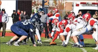  ??  ?? Pottstown and Owen J. Roberts prepare for action at the line of scrimmage during their Thanksgivi­ng Day game Thursday.