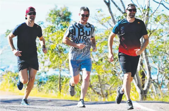  ?? Picture: ZAK SIMMONDS ?? ON TRACK: Triple Eight team members Jamie Whincup, Craig Lowndes and Shane van Gisbergen put the finishing touches to their training for this weekend’s Townsville 400 with a run up Castle Hill yesterday morning.