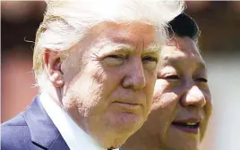  ?? (AP) ?? US President Donald Trump and Chinese President Xi Jinping walk together at Mar-a-Lago in Palm Beach, Florida.