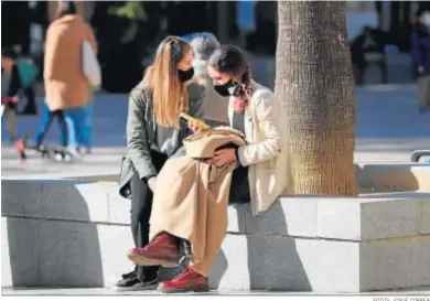  ?? FOTOS: JOSUÉ CORREA ?? Unas jóvenes sentadas al sol en la céntrica plaza de las Monjas en una jornada dominical fría.