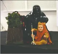  ??  ?? David Violett and little Willow — dressed as Darth Vader and an Ewok from “Star Wars” — earned a loud “Aww” from the crowd when they entered the costume contest, as the little girl grabbed her spear and smiled. Willow won first place in the children’s...