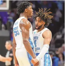  ?? ASSOCIATED PRESS ?? North Carolina’s RJ Davis (4) and Harrison Ingram (55) celebrate a 3-pointer against Michigan State during an 85-69 Tar Heels win in the second round of the NCAA Tournament on Saturday in Charlotte, N.C.