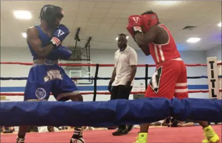  ?? KEVIN MARTIN — THE MORNING JOURNAL ?? Kemp Tarver, left, and Armond Richards compete in the Steel City Storm youth boxing tournament at Sacred Heart Chapel in Lorain on Aug. 25.