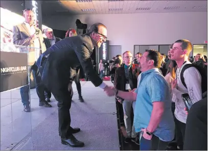  ?? TODD PRINCE/ LAS VEGAS REVIEW-JOURNAL ?? Hakkasan CEO Neil Moffitt, left, talks with attendees Monday during the Nightclub and Bar Show at the Las Vegas Convention Center. He said Wet Republic generated $44 million in revenue in 20 weeks last year.