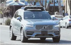  ?? FILE PHOTO BY SIPA VIA AP ?? ON PAUSE: An Uber self-driving autonomous vehicle seen driving in Tempe, Ariz., in February.