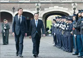  ?? LI TAO / XINHUA ?? Premier Li Keqiang is accompanie­d by Dutch Prime Minister Mark Rutte at a welcoming ceremony at the Binnenhof, the Dutch government center, in The Hague, Netherland­s, during his three-day official visit, which began on Sunday.