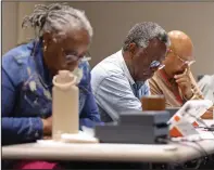  ?? (Arkansas Democrat-Gazette/Colin Murphey) ?? Election workers, including Garland Nelson (center), wait for voters to show up at a polling station across the street from city hall in downtown Little Rock for early voting for the runoff election Monday.