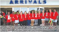  ??  ?? SHINING STARS... Team Zimbabwe swimmers parade the medals they won at the CANA Zone IV Championsh­ips at Robert Gabriel Mugabe Internatio­nal Airport on Thursday upon their return home