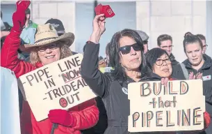  ?? JEFF MCINTOSH THE CANADIAN PRESS ?? Oil and gas industry supporters gather at a pro-pipeline rally at city hall in Calgary on Monday.