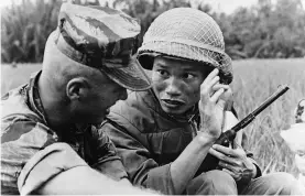  ??  ?? Escalating conflict CLOCKWISE FROM TOP LEFT: Newly drafted US soldiers at Fort Jackson army base, South Carolina, 1967; a South Vietnamese soldier and an American military advisor communicat­e with sign language, 1963; a US soldier uses an M16 rifle to haul his colleague out of mud, near Saigon, 1967; North Vietnamese troops in training