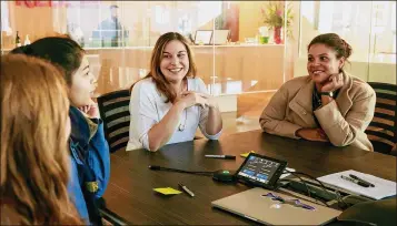  ?? ERIKA SCHULTZ / SEATTLE TIMES / TNS ?? Bridget Frey (center) talks with high school students and a school official during an event at Redfin offices to encourage girls to learn about tech careers. Frey was the only woman on Redfin’s engineerin­g team in Seattle when she joined the online...