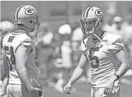  ?? JIM MATTHEWS / USA TODAY NETWORK-WISCONSIN ?? New Packers punter Justin Vogel (right) talks with long snapper Derek Hart during OTAs Thursday in Green Bay.