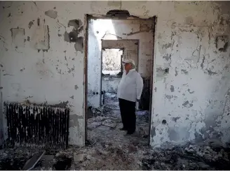  ??  ?? Athanassio­s Gantonas, stands inside his burnt house following a wildfire in the village of Mati, near Athens, yesterday. Tragedies will continue to happen unless the state gets its act together and people change their mentality.