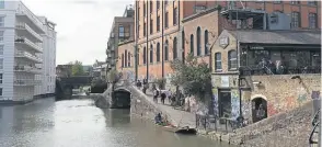  ?? PHOTO: CRT ?? The Dead Dog Bridge carrying the Regent’s Canal towpath across the canal basin beneath the Camden Interchang­e Warehouse.