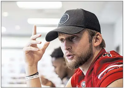  ?? Arkansas Democrat-Gazette/MITCHELL PE MASILUN ?? Arkansas State senior quarterbac­k Justice Hansen talks to reporters during media day Thursday at the ASU football complex in Jonesboro. The Sun Belt Offensive Player of the Year is back to lead the offense after a 2017 season in which he threw for 3,967 yards and 37 touchdowns and completed 62.6 percent of his passes.