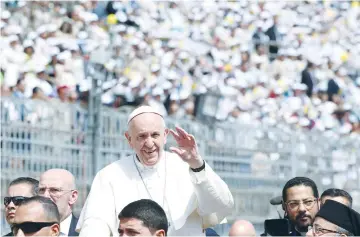  ??  ?? POPE FRANCIS waves as he arrives to lead a mass in Cairo yesterday.