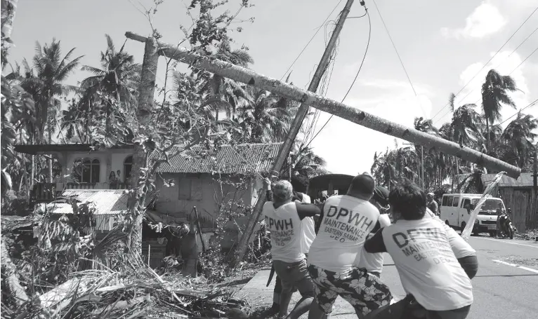  ?? AFP PHOTO ?? WORKERS pull a fallen electric pylon damaged at the height of Typhoon Phanfone in Salcedo town in Eastern Samar. Typhoon Phanfone swept across remote villages and popular tourist areas of the central Philippine­s on Christmas day claimed at least 16 lives, authoritie­s said.