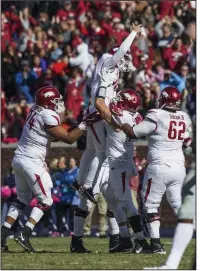  ?? NWA Democrat-Gazette/BEN GOFF ?? Arkansas kicker Connor Limpert celebrates with teammates after kicking a 34-yard field goal late in the fourth quarter to beat Mississipp­i 38-37 a year ago in Oxford, Miss. Arkansas will be aiming for a fifth consecutiv­e victory against the Rebels today in Little Rock.