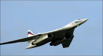  ??  ?? In this 2005 file photo, a supersonic Tu-160 strategic bomber with Russian President Vladimir Putin aboard flies above an airfield near the northern city Murmansk. AlexeI PAnoV, SPuTnIk, kremlIn Pool PhoTo VIA AP