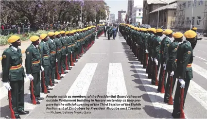  ?? — Picture: Believe Nyakudjara ?? People watch as members of the Presidenti­al Guard rehearse outside Parliament building in Harare yesterday as they prepare for the official opening of the Third Session of the Eighth Parliament of Zimbabwe by President Mugabe next Tuesday