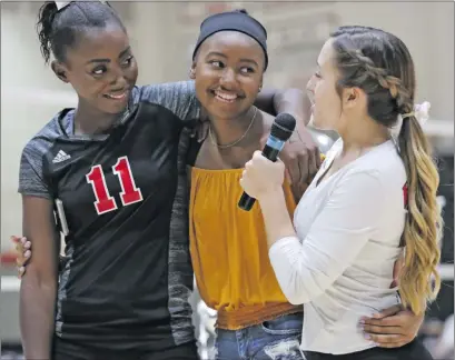  ?? Katharine Lotze/The Signal (See additional photos on signalscv.com) ?? Hart’s Alyssa Cosey, center, smiles as she’s embraced by sister Ashley, left, and teammate MacKenna Fall, left, ahead of a “Kills for Cancer” fundraiser during a regular league volleyball game against Valencia on Tuesday.