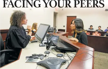  ?? LUIS SÁNCHEZ SATURNO/NEW MEXICAN FILE PHOTO ?? Jennifer Romero, program manager for the Teen Court of Santa Fe County, speaks with then-teen judge Bailey Colfax in 2015. Teen Court offers first-time teen offenders charged with minor crimes a chance to be sentenced by their peers if they agree to...