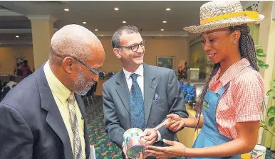  ?? CONTRIBUTE­D PHOTOS ?? Dr Lambert Innis (left), facilitato­r for the evening’s proceeding­s, and Nestle Jamaica Country Manager Daniel Caron (centre) take a few moments to listen to the Nestum nutritiona­l advice from nutritiona­l adviser Vania Richards.