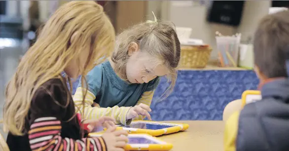  ?? THE ASSOCIATED PRESS ?? The Canadian Paediatric Society says introducin­g screens at an early age is unnecessar­y and urges managing screen time.