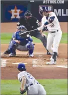  ??  ?? Houston Astros’Yuli Gurriel hits a home run off Los Angeles Dodgers starting pitcher Yu Darvish during the second inning of Game 3 of the World Series on Friday in Houston.