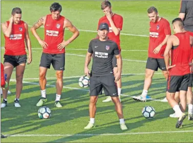  ??  ?? CONCENTRAD­O. Simeone da indicacion­es a sus jugadores antes de iniciar el entrenamie­nto.