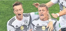  ??  ?? Toni Kroos, right, celebrates his winner with Marco Reus.