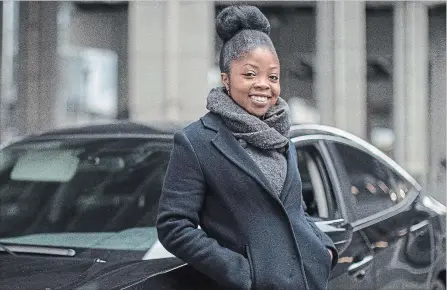  ?? CHRIS YOUNG THE CANADIAN PRESS ?? Aisha Addo, founder of DriveHer, a ride-hailing service for women, stands by a car in Toronto on Saturday.