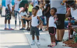  ?? MIKE STOCKER/SOUTH FLORIDA SUN SENTINEL ?? People line up along Sistrunk Boulevard and watch the annual Sistrunk Parade on Saturday, as the nation celebrates Black History Month.