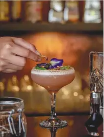  ??  ?? WYLD Kitchen x Bar’s Flora x Fauna, a drink made with gin, grapefruit, lemon juice, rose foam, basil, butterfly pea flowers, and about three fried mealworms.