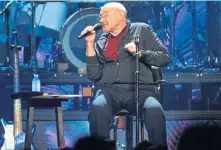  ?? PHOTOS BY CHRIS CHRISTO, BOSTON HERALD ?? AGAINST ALL ODDS: Physical ailments may have kept Phil Collins in a chair and not behind his drum kit but he put on an impassione­d performanc­e Tuesday night.